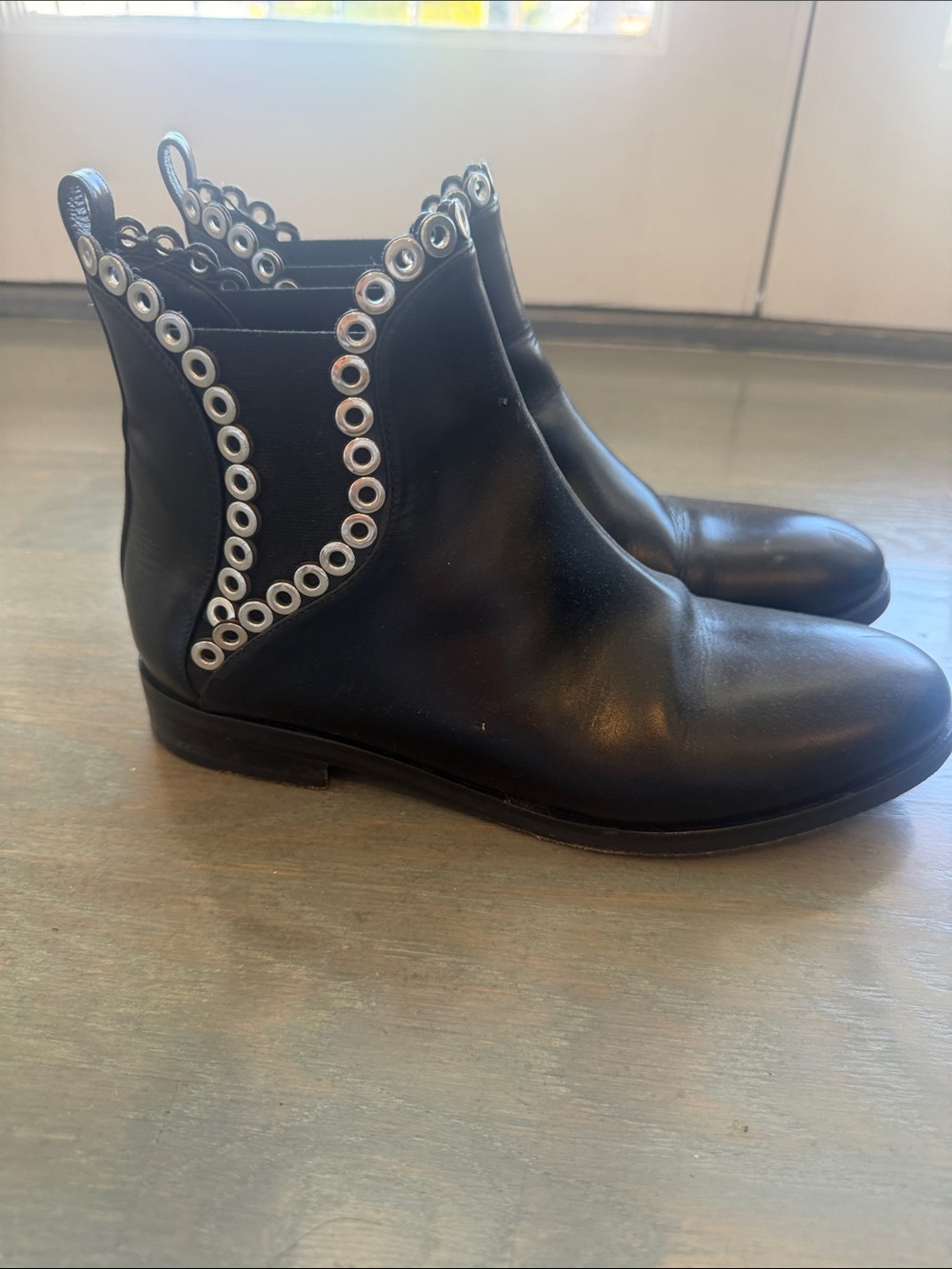 Alaia Black Leather Chelsea Boots with Silver Eyelet Trim